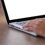 Contractor reviewing job management software tools online